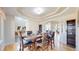 Elegant dining room featuring wood floors and a coffered ceiling with classic furnishings at 9353 E 146Th Ave, Brighton, CO 80602