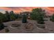 A beautifully landscaped home illuminated by a vibrant sunset at 9353 E 146Th Ave, Brighton, CO 80602