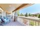 Relaxing front porch features comfortable seating, a stone facade, and lovely neighborhood views at 9353 E 146Th Ave, Brighton, CO 80602