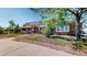 Charming home with lush landscaping, mature trees, and stone accents at 9353 E 146Th Ave, Brighton, CO 80602