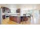 Gourmet kitchen with granite counters, stainless steel appliances, and a center island with breakfast bar at 9353 E 146Th Ave, Brighton, CO 80602
