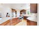 Modern kitchen featuring stainless steel appliances, granite countertops and hardwood floors at 9353 E 146Th Ave, Brighton, CO 80602