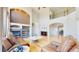 Open-plan living room featuring a cozy fireplace, hardwood flooring, and plenty of natural light at 9353 E 146Th Ave, Brighton, CO 80602