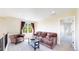 Cozy living room features a comfortable couch, oversized chair, and a sunlit window at 9353 E 146Th Ave, Brighton, CO 80602