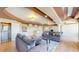 Open-concept living room with modern lighting, hardwood floors, and comfortable seating at 9353 E 146Th Ave, Brighton, CO 80602