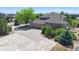 Rear exterior view showing the multi-car garage, well-maintained lawn, and mature trees at 9353 E 146Th Ave, Brighton, CO 80602