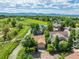Aerial view showcases the home's location near a river, green spaces, and mountain views in the distance at 10478 W 82Nd Ave, Arvada, CO 80005