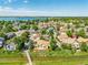 Aerial view of a residential neighborhood, trees, and a walking bridge on a sunny day with a lake in the background at 10478 W 82Nd Ave, Arvada, CO 80005