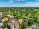 Aerial view of homes surrounded by greenery with a walking path and bridge with blue skies in a picturesque neighborhood at 10478 W 82Nd Ave, Arvada, CO 80005