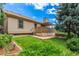 Well-manicured backyard featuring a patio, deck, mature trees, and lush lawn for outdoor enjoyment at 10478 W 82Nd Ave, Arvada, CO 80005