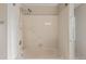 Bathroom tub and shower with grab bars and neutral tile at 10478 W 82Nd Ave, Arvada, CO 80005
