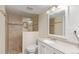 Neutral bathroom with tiled shower and decorative river rock floor at 10478 W 82Nd Ave, Arvada, CO 80005