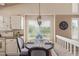 Bright dining area features a round table, chair seating, pendant lighting and built in window seat at 10478 W 82Nd Ave, Arvada, CO 80005