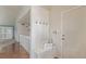 Charming entryway with wainscotting, coat hooks, storage bench, and 'Welcome' pillow at 10478 W 82Nd Ave, Arvada, CO 80005