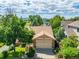 Aerial view of a charming home with a well-manicured lawn, mature trees, and a peaceful neighborhood setting at 10478 W 82Nd Ave, Arvada, CO 80005