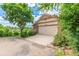 Inviting single-Gathering house with a two-car garage, green lawn, and colorful flowerbeds enhancing its curb appeal at 10478 W 82Nd Ave, Arvada, CO 80005
