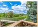 Scenic view from the deck overlooking a lush landscape and serene river with a walking bridge at 10478 W 82Nd Ave, Arvada, CO 80005