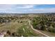 Wide aerial view of the community, showcasing green spaces, walking path, and panoramic mountain views at 20816 E Shefield Pl, Parker, CO 80138