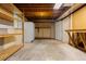Unfinished basement provides ample storage with shelving and a refrigerator, ready for customization at 20816 E Shefield Pl, Parker, CO 80138