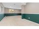 Basement with two-toned walls and large windows is carpeted and ready to be transformed for your needs at 20816 E Shefield Pl, Parker, CO 80138