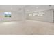 Spacious carpeted basement with bright windows and neutral decor, offering ample potential for customization at 20816 E Shefield Pl, Parker, CO 80138
