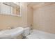 Cozy bathroom features a combination bathtub and shower with neutral tile and a classic pedestal sink at 20816 E Shefield Pl, Parker, CO 80138
