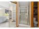 Bathroom featuring walk in shower, tub, shelving and modern gray cabinets at 20816 E Shefield Pl, Parker, CO 80138