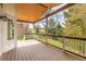 Large covered deck with wooden railing and ceiling is perfect for relaxing outdoors while enjoying views at 20816 E Shefield Pl, Parker, CO 80138