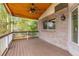 Covered wooden deck with ceiling fan, brick siding, and backyard views is the perfect outdoor entertaining space at 20816 E Shefield Pl, Parker, CO 80138