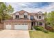 Charming two-story home with a three-car garage and a well-maintained lawn at 20816 E Shefield Pl, Parker, CO 80138