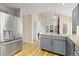 Spacious kitchen featuring stainless steel refrigerator, granite countertops, and seamless access to an adjacent living room at 20816 E Shefield Pl, Parker, CO 80138