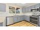Modern kitchen with granite countertops, stainless steel appliances, and light grey cabinets at 20816 E Shefield Pl, Parker, CO 80138