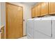 Laundry room with washer and dryer, cabinets, and access to the outside at 20816 E Shefield Pl, Parker, CO 80138