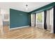Inviting living room with vibrant green accent wall, new hardwood floors and bright natural light at 20816 E Shefield Pl, Parker, CO 80138