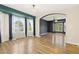 Bright living room with hardwood flooring, large windows, and seamless access to an adjacent room at 20816 E Shefield Pl, Parker, CO 80138