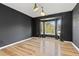 Large living room with dark accent wall, hardwood floors, bay windows and plenty of natural light at 20816 E Shefield Pl, Parker, CO 80138