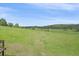 Lush backyard with trees and a scenic view from the wooden deck at 26085 Amy Cir, Conifer, CO 80433