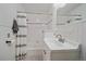 Clean bathroom with a shower-tub combo, white tile, and modern fixtures at 26085 Amy Cir, Conifer, CO 80433