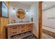 Stylish bathroom with decorative vanity, vessel sink, and a tiled shower/tub at 26085 Amy Cir, Conifer, CO 80433