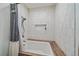 Bright bath featuring a shower with a vertical subway tile surround and built-in niche at 26085 Amy Cir, Conifer, CO 80433