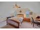 Cozy bedroom featuring a wooden bed frame, neutral colored walls, and natural light at 26085 Amy Cir, Conifer, CO 80433