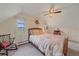 Attic bedroom with neutral walls, a wooden bed frame, and natural lighting at 26085 Amy Cir, Conifer, CO 80433