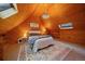 Attic bedroom with wood paneling, a chandelier, and a cozy atmosphere at 26085 Amy Cir, Conifer, CO 80433