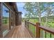 Wooden deck with views of a green meadow, trees, and blue skies at 26085 Amy Cir, Conifer, CO 80433
