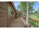 Spacious wooden deck offering scenic views of the surrounding meadow, creating an inviting outdoor space at 26085 Amy Cir, Conifer, CO 80433
