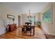 Bright dining room with hardwood floors, a chandelier, and a view of the outdoors at 26085 Amy Cir, Conifer, CO 80433