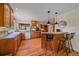 Kitchen featuring wood cabinets, a breakfast bar, natural light, and modern appliances at 26085 Amy Cir, Conifer, CO 80433