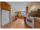 Bright kitchen featuring wood cabinets, stone accents, stainless appliances, and natural light at 26085 Amy Cir, Conifer, CO 80433
