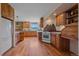 Spacious kitchen featuring wood cabinets, tile counters, stainless appliances, and a stunning mountain view at 26085 Amy Cir, Conifer, CO 80433
