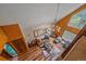 Open living room with hardwood floors, natural lighting, and a unique chandelier overhead at 26085 Amy Cir, Conifer, CO 80433